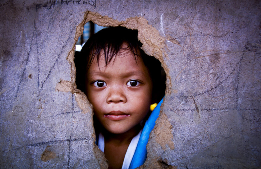 Boy looking out from rescue center in the Philippines.